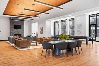 a living room with a table and chairs and a fireplace